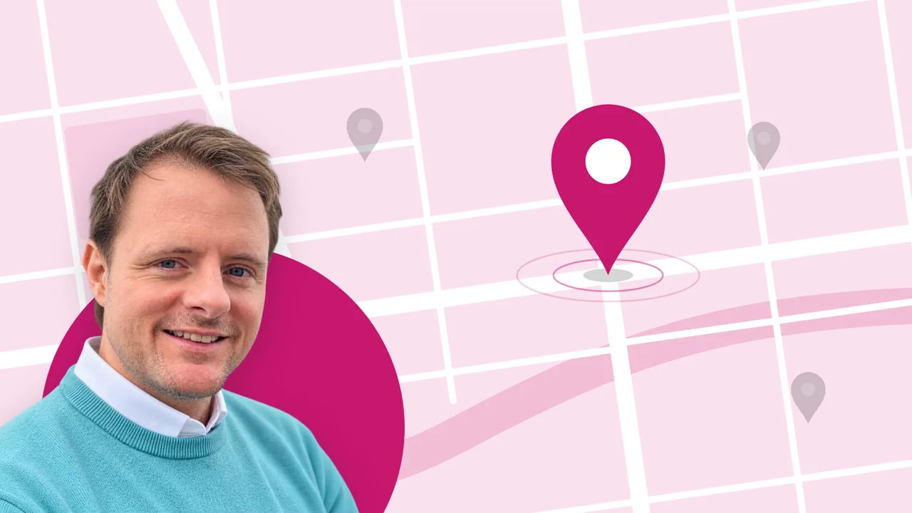 Alan Buchanan in front of a street map where one business is marked by a large magenta pin and the others in grey